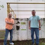 Lucy Electric Brazil team standing beside protected Jataí bee hive on facility wall