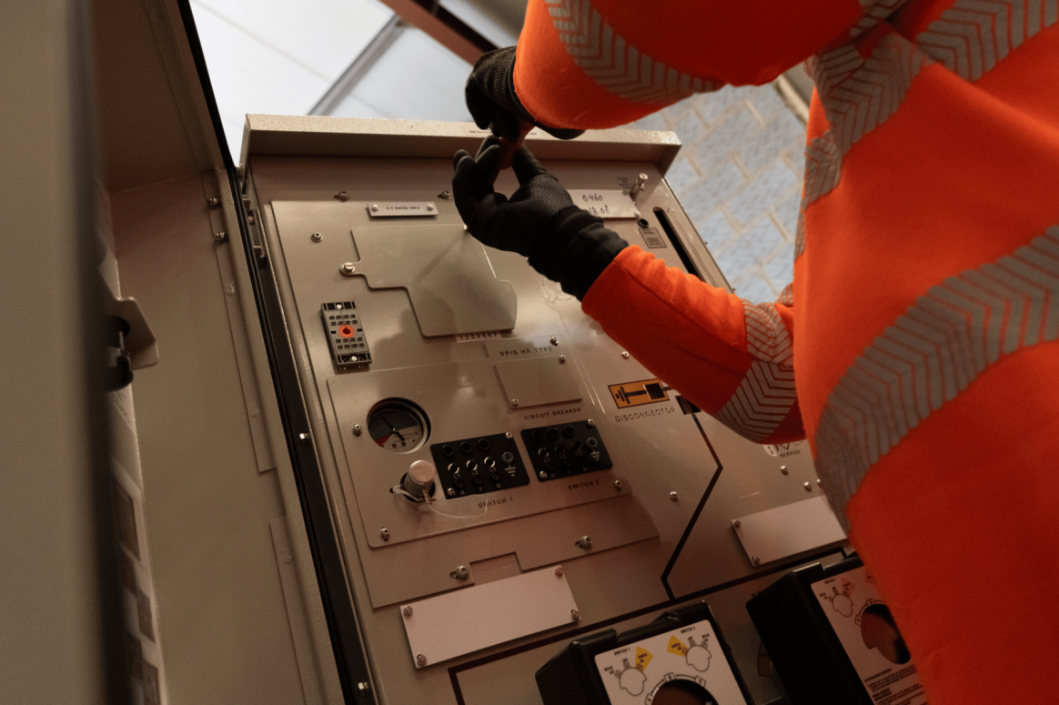 Engineer carrying out HV and LV electrical maintenance on switchgear at One Southampton Row commercial building in Holborn London